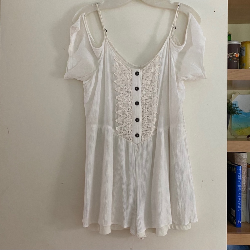 White romper with lace detailing and buttons